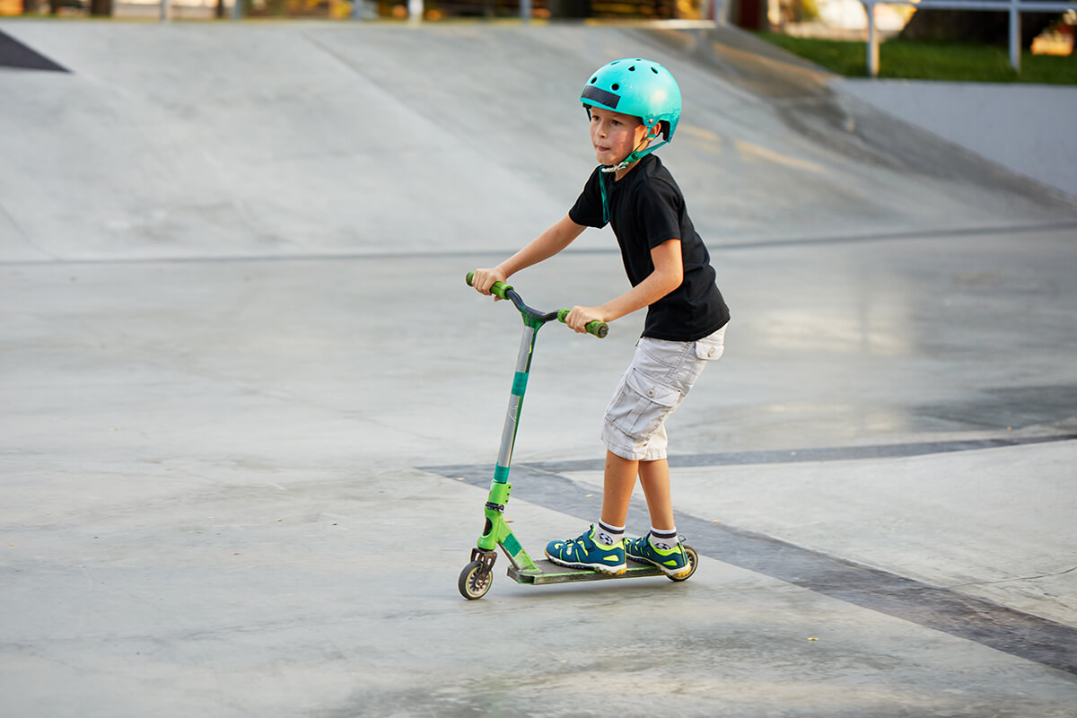kind_mit_helm_im_skatepark