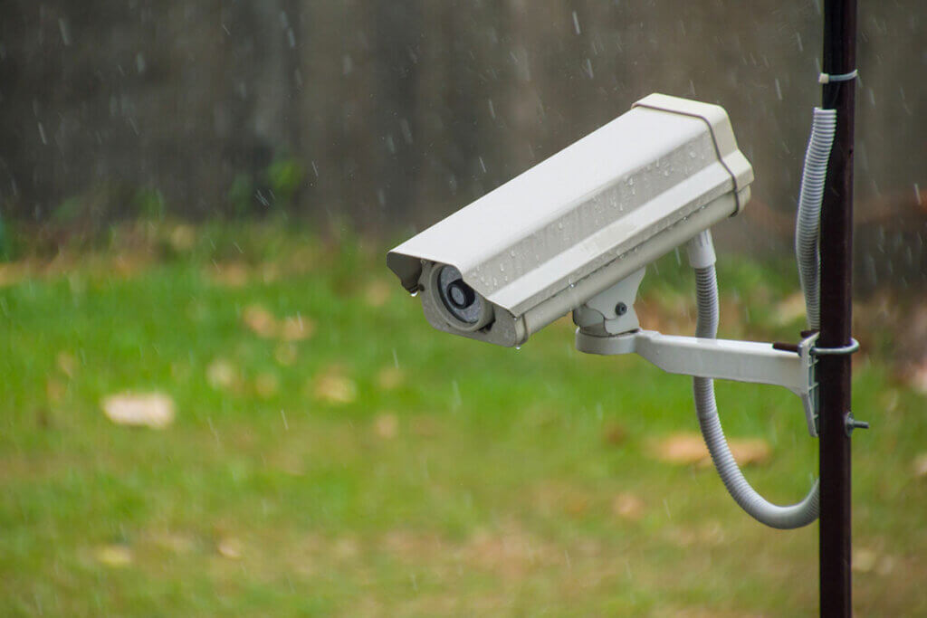 Eine Ueberwachungskamera haengt im Regen